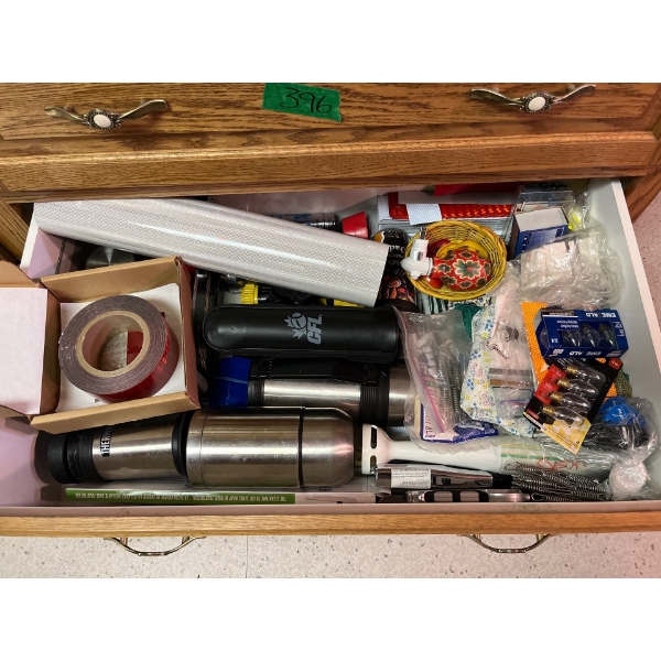 drawer full of coffee, urns, thermoses, lighters, aprons, corn holders, and reflective tape all sold