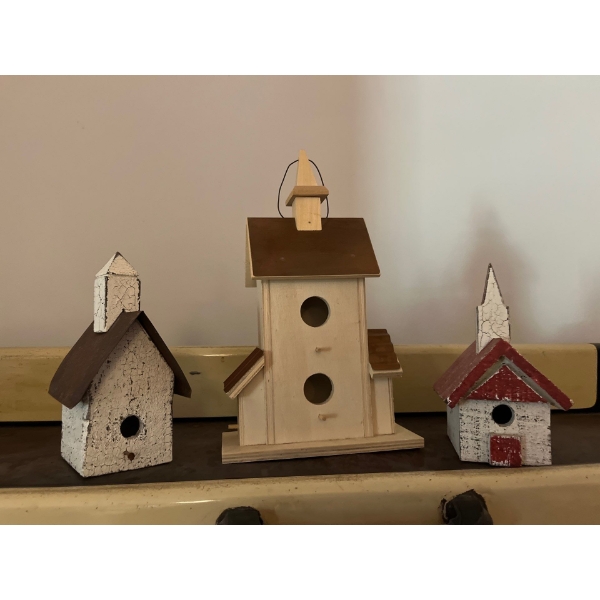 three white bird houses