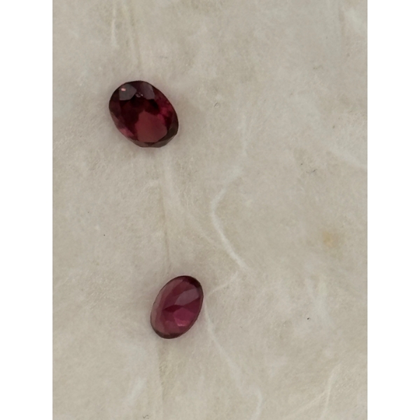 2 garnets small one purple and red colour clarity is moderate cut medium is 1.08 carrots small garne
