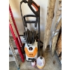 Image 1 : STIHL RE 129 PLUS pressure washer with a jug of washer fluid