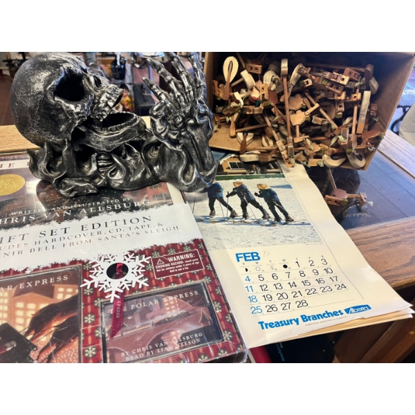 Skull bottle holder some piano keys, a vintage treasury branch wall calendar and the Polar Express g