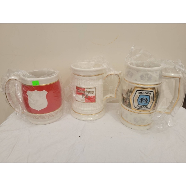 Three Ceramic Beer Steins with Brewery Branding and Gold Accents