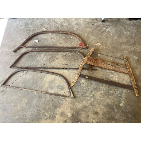  Collection of 4 Antique Saws 3 metal framed and 1 wood framed .