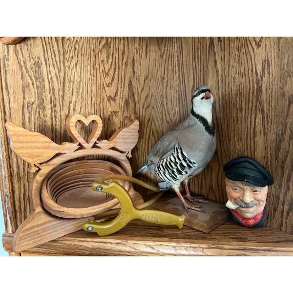 Sling shott. Applied for Bow, stuffed bird, ceramic sailor and wooden basket