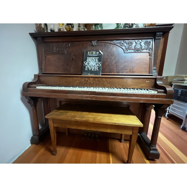 beautiful antique piano with bench . Beautiful wooden design .