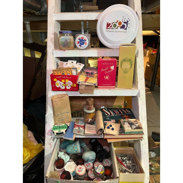 assortment of mini Avon bottles, some vintage hair clips, sewing magazine with extensive collection 