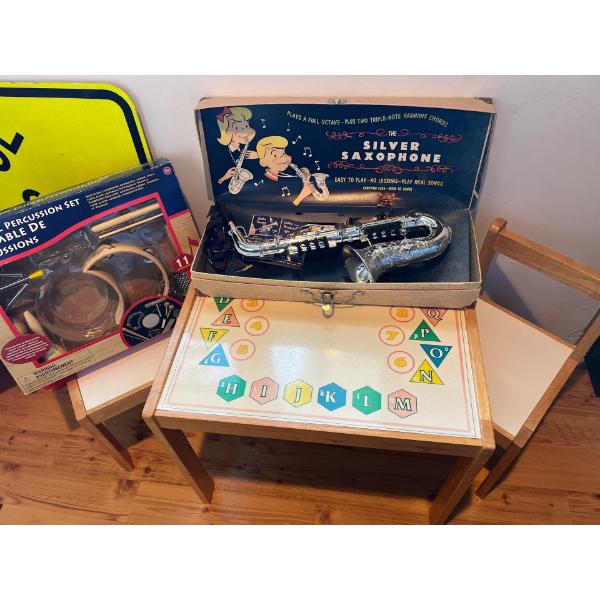 children’s table with two chairs, alphabet and numbers as well as a kids play plastic silver saxopho