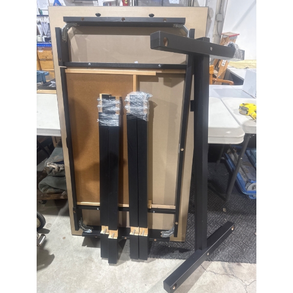 Disassembled Black Metal Table Frame With Wooden Components