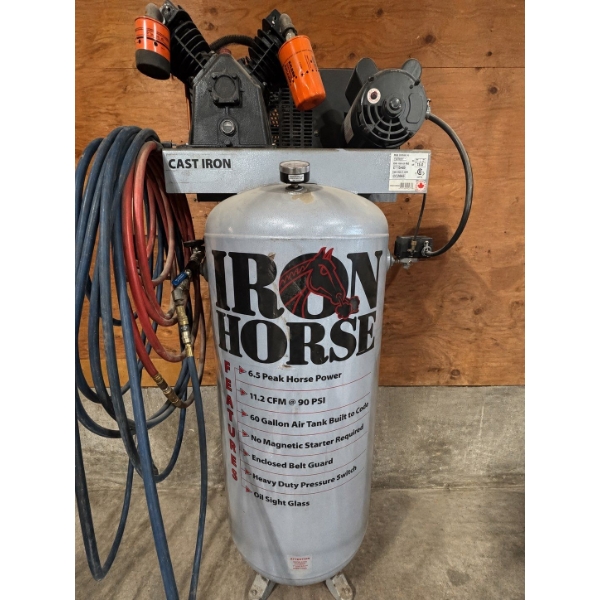 60 gallon air compressor manufactured by Iron Horse with hoses and other attachments ready for the n