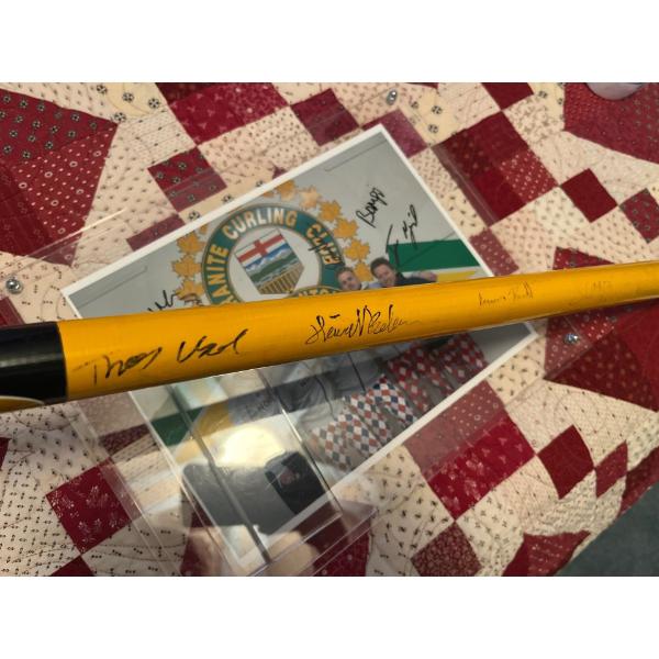 autographed picture and curling broom by the Norwegian curling team at the Granite curling club in E