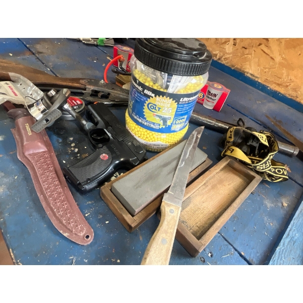  pellet, guns, fillet knives, fishing reel shot glass collection, and a vintage sharpening stone