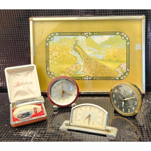 Decorative Clocks, Philishave Razor, and Peacock Artwork Display