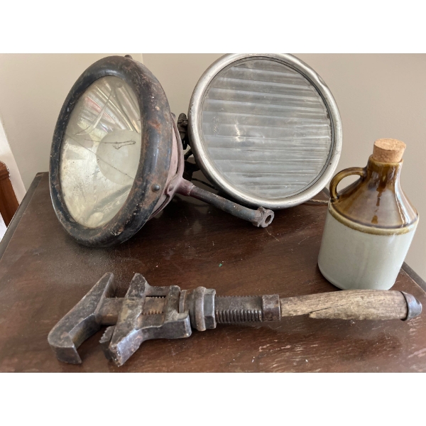 Two large brass and stainless steel headlamps possibly from Ford model A’s along with the vintage an