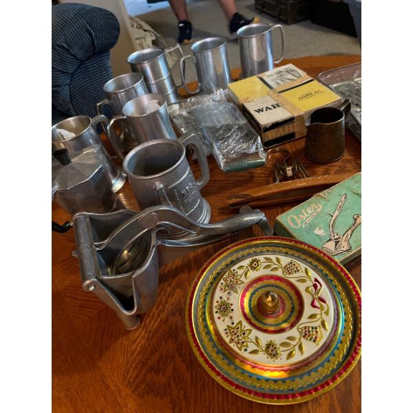 collection of pewter cups, vintage wheel, trimmer, juicer, and vintage cheese grater