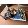 Image 2 : cart with battery charger and jumper cables with a selection of antique power line insulators .