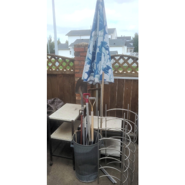 Outdoor Lot With Blue Patio Umbrella, Yard Tools, Rolling Tables