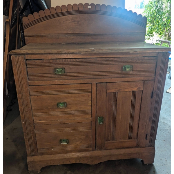 Oak Sideboard with Green Glass Drawer Pulls and Scalloped Backsplash