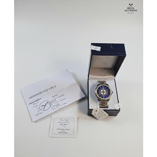  Two-Tone Design With A Blue Dial, Roman Numerals, And A Compass-Style Motif Labeled "True North Str