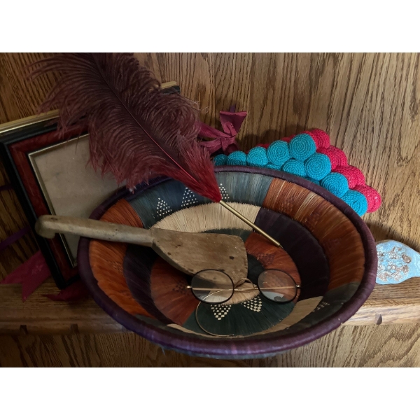 Woven basket, feather pen, carved wooden spat chela, antique glasses ( missing ear piece) frames, co