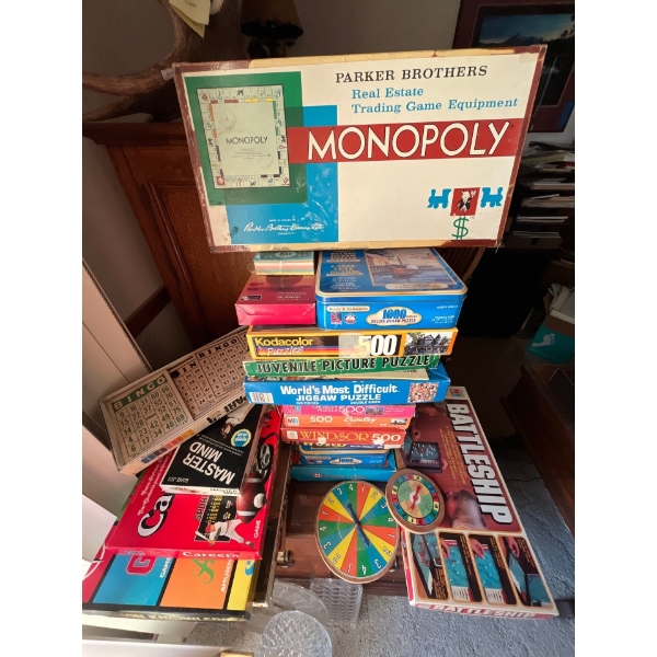 collection of puzzles and vintage games monopoly, battleship, bingo mastermind, common knowledge, cl