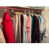 Image 1 : Collection of vintage women’s clothing, shirts, skirts, and two full length trench coats, all in gre