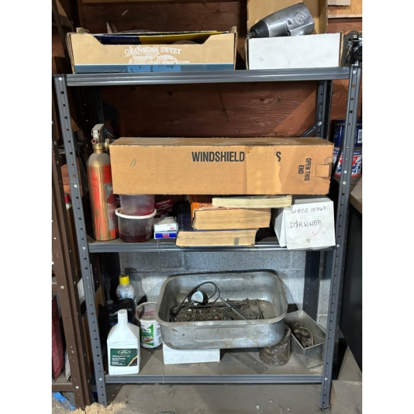 metal shelf with miscellaneous items, box full of sand, paper, brand new windshield, wiper blades