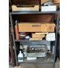Image 1 : metal shelf with miscellaneous items, box full of sand, paper, brand new windshield, wiper blades