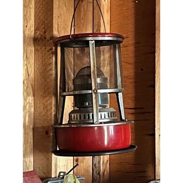 large antique kerosine heater with small, kerosene, red lamp