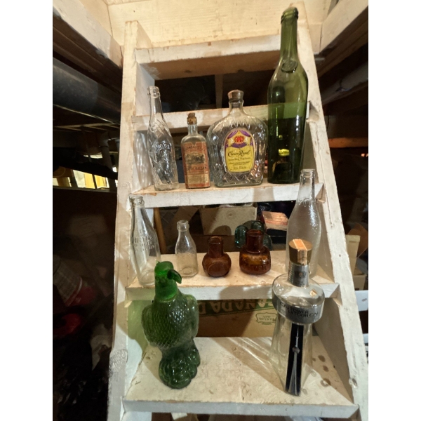 collection of random bottles crown royal whistle Welsh‘s juices a CN Tower liquor bottle from the 70