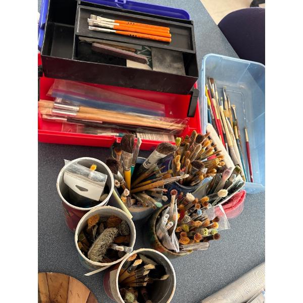 Several unused & used paint brushes for all your crafting needs .