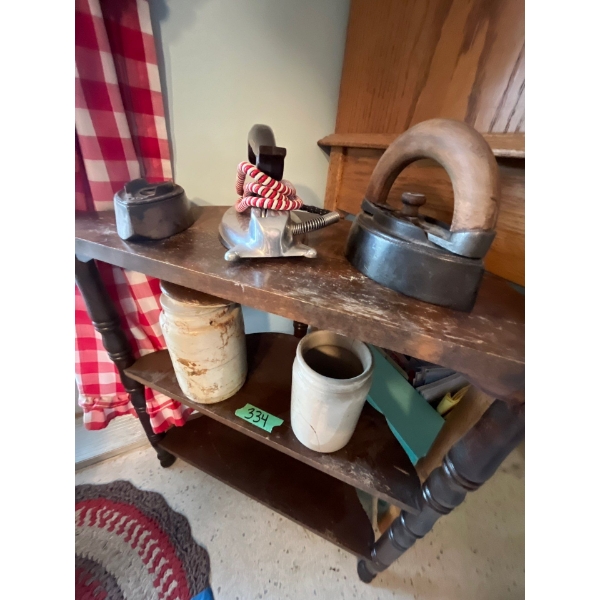 antique small corner table with two antique irons, one with folder and a vintage electric iron and t