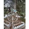 Image 1 : Large wagon wheel with yard signs large antique saw and two flower boxes.