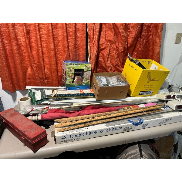 all contents of table, including several vintage meter sticks, put away outdoor pet barrier, huge ju