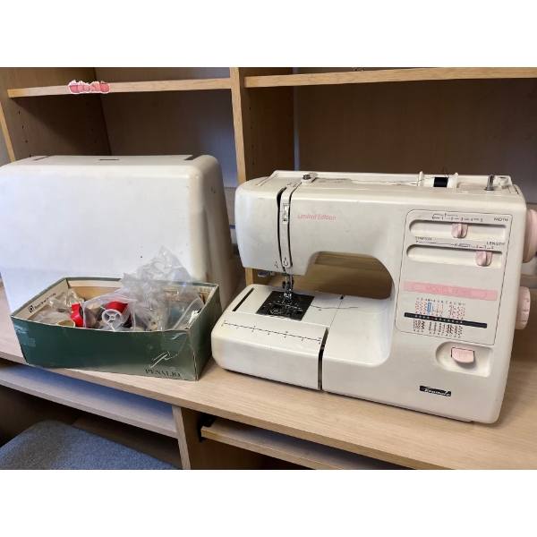 Kenmore, limited edition, sewing machine with pedal and a number of bobs of threadK