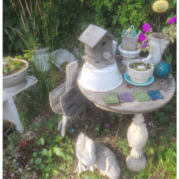 Rustic Garden Decor With Wire Spool Table, Birdhouse, and Duck Statues