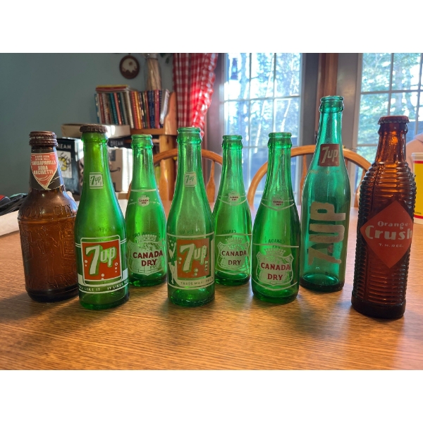 collection of 7  up  Canada dry  one Brown Orange crush bottle. 