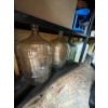 Image 7 : Two metal storage shelves with contents, 320 L water jugs, hammocks lights, tarps, glass carboys, an
