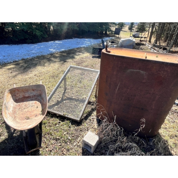 Wheelbarrow dirt, sifter, and farm fuel tank.