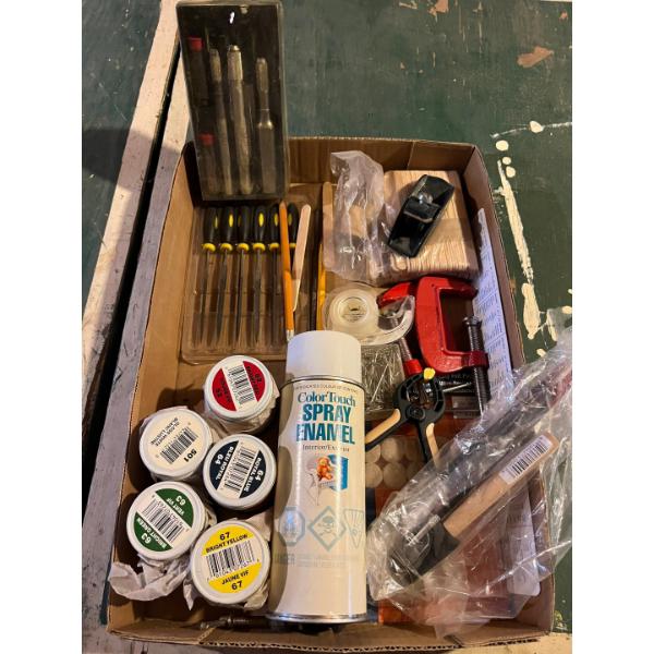 collection of paint, cutting tools, clamps, and other crafting supplies