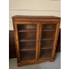 Image 1 : A dark wood, two-door cabinet with glass panels designed to showcase delicate collectibles 

44”L x 