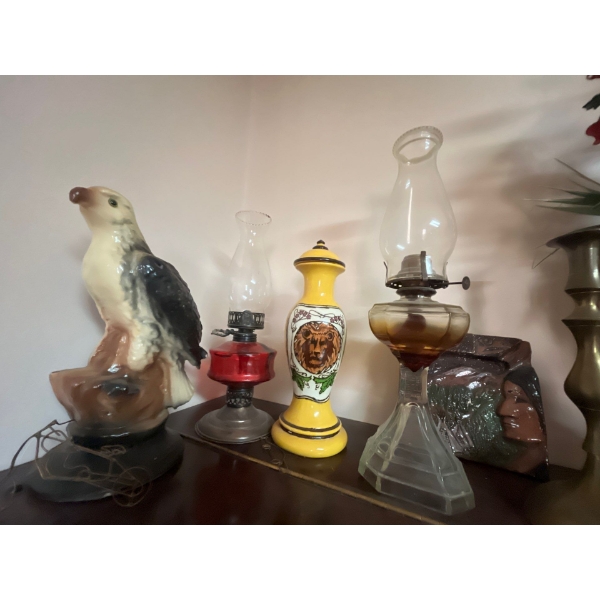 collection of antique oil lanterns, glasses, small pieces of wire art, and a ceramic eagle and two b