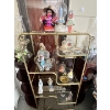 Image 1 : Collection of vintage figurines, dolls, and decorative items displayed on a brass and glass etagere,