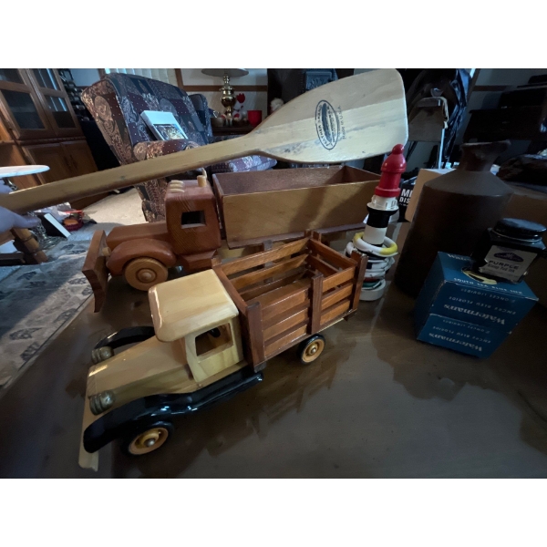 Wooden toy trucks, vintage ink for ink walls, small wooden paddle and light wooden lighthouse game.