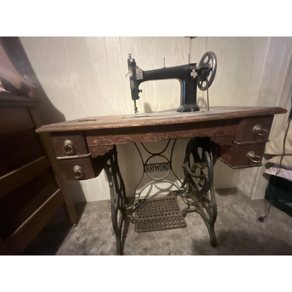 Raymond pedal Drive sewing Machine with beautiful wood cabinet .