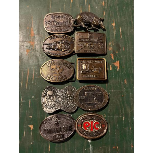 collection of vintage belt buckles from France, Alberta oil patch Yamaha skis and a armadillo all ve