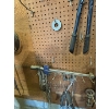Image 6 : pegboard with various tools, including bolt cutters gear, polars, hacksaw, bungee cords, vice grips,