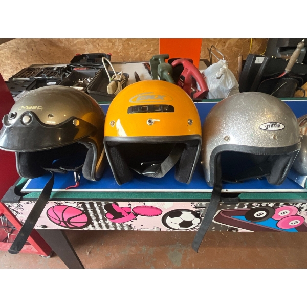collection of cool, vintage helmets and a bicycle helmet