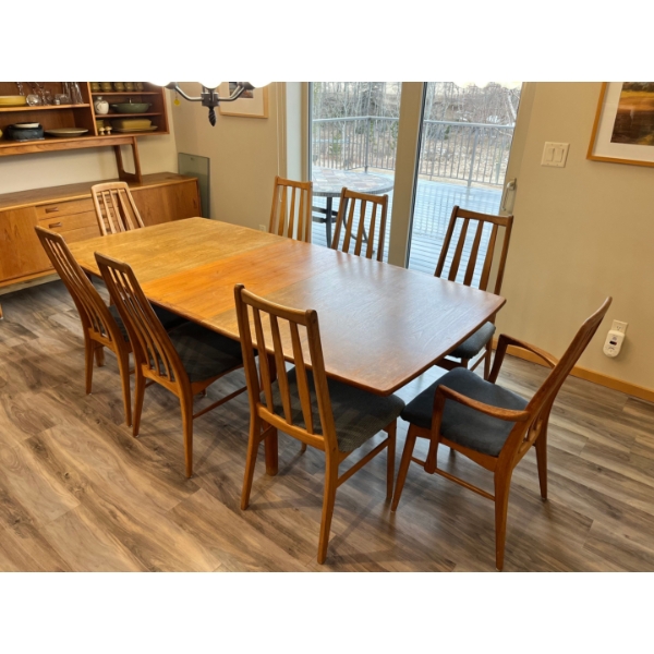Vintage teak, dining room table. With 2 extensions and 10 padded chairs this is a beautiful peace of