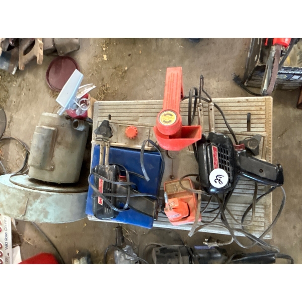 small saw bench with three soldering irons and a motor and blower