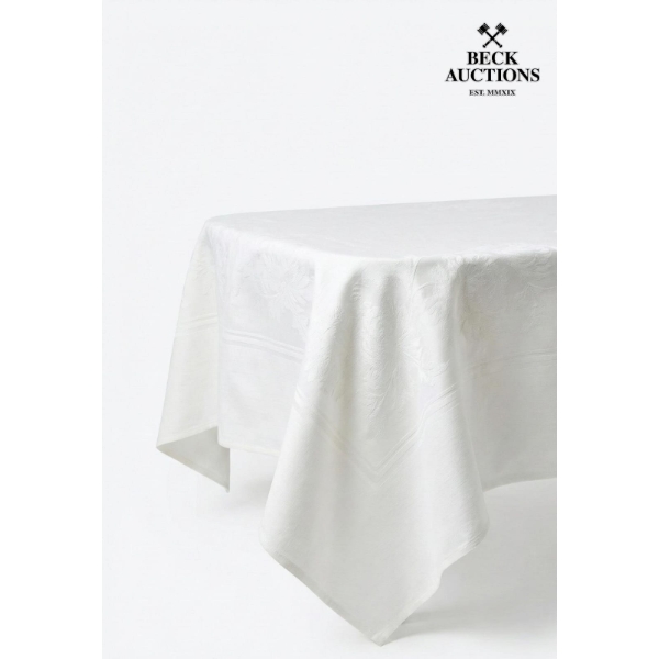 white damask tablecloth with a raised floral pattern.